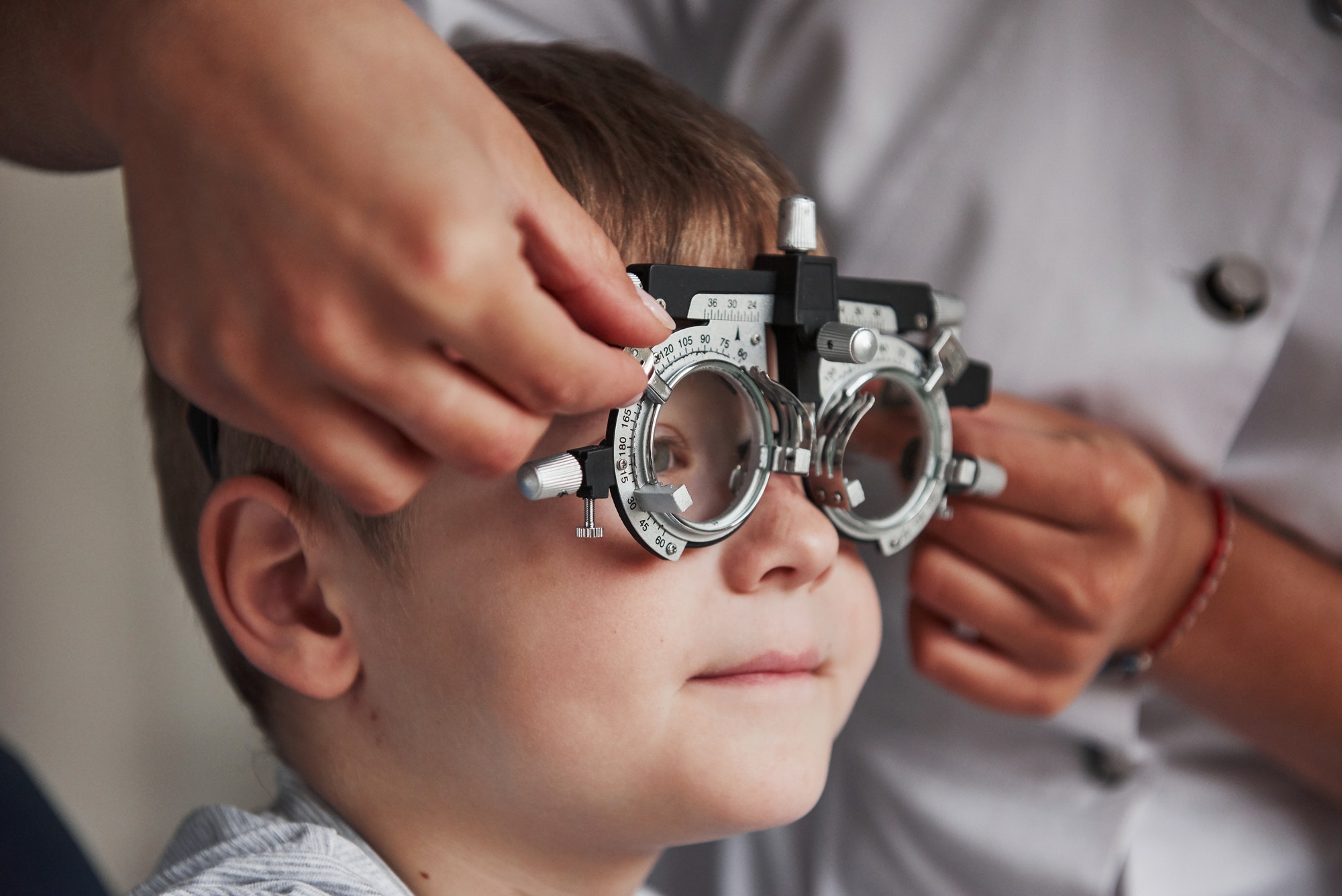Close up portrait of child in special glasses in ophthalmologist cabinet